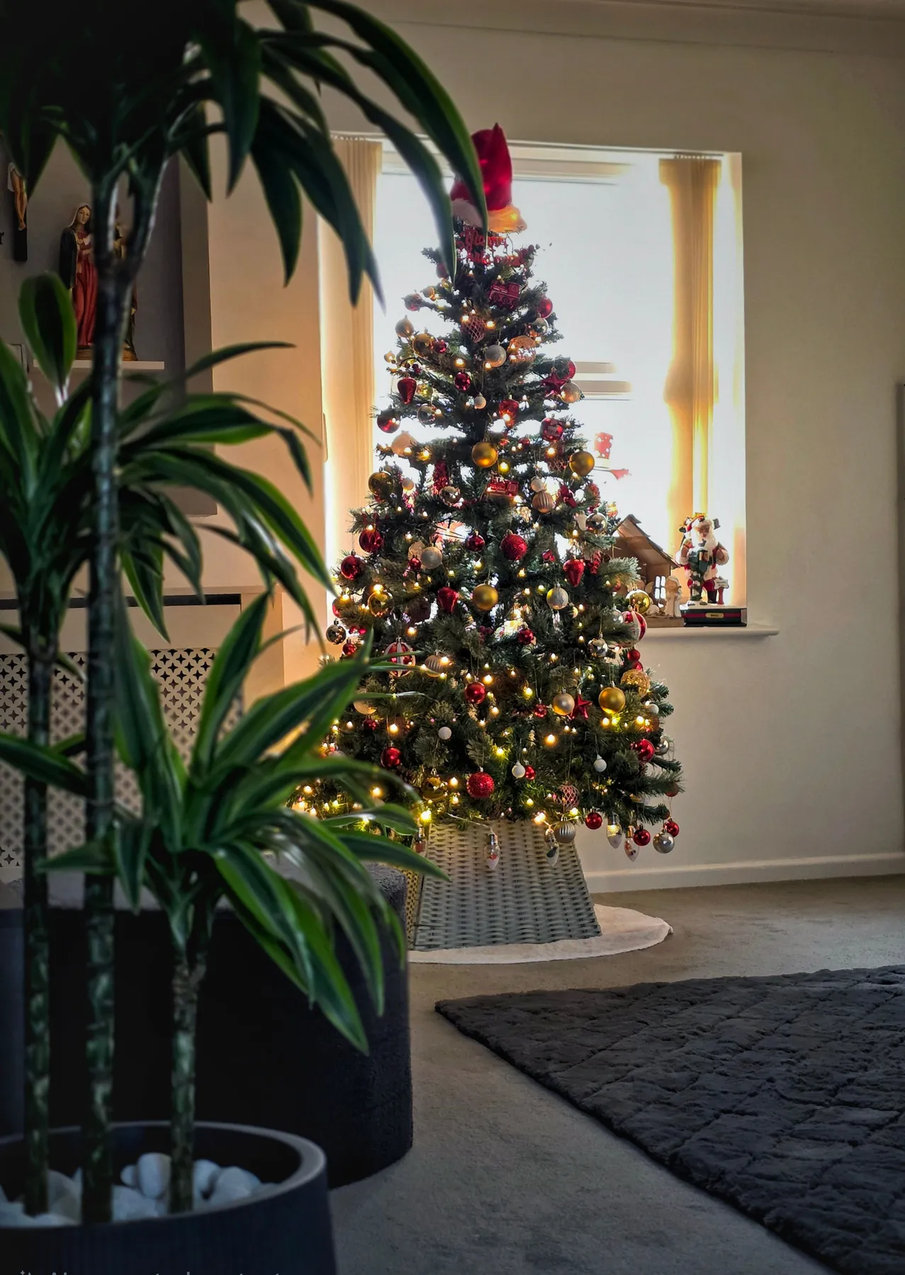 A beautifully decorated Christmas tree in a cozy living room interior.