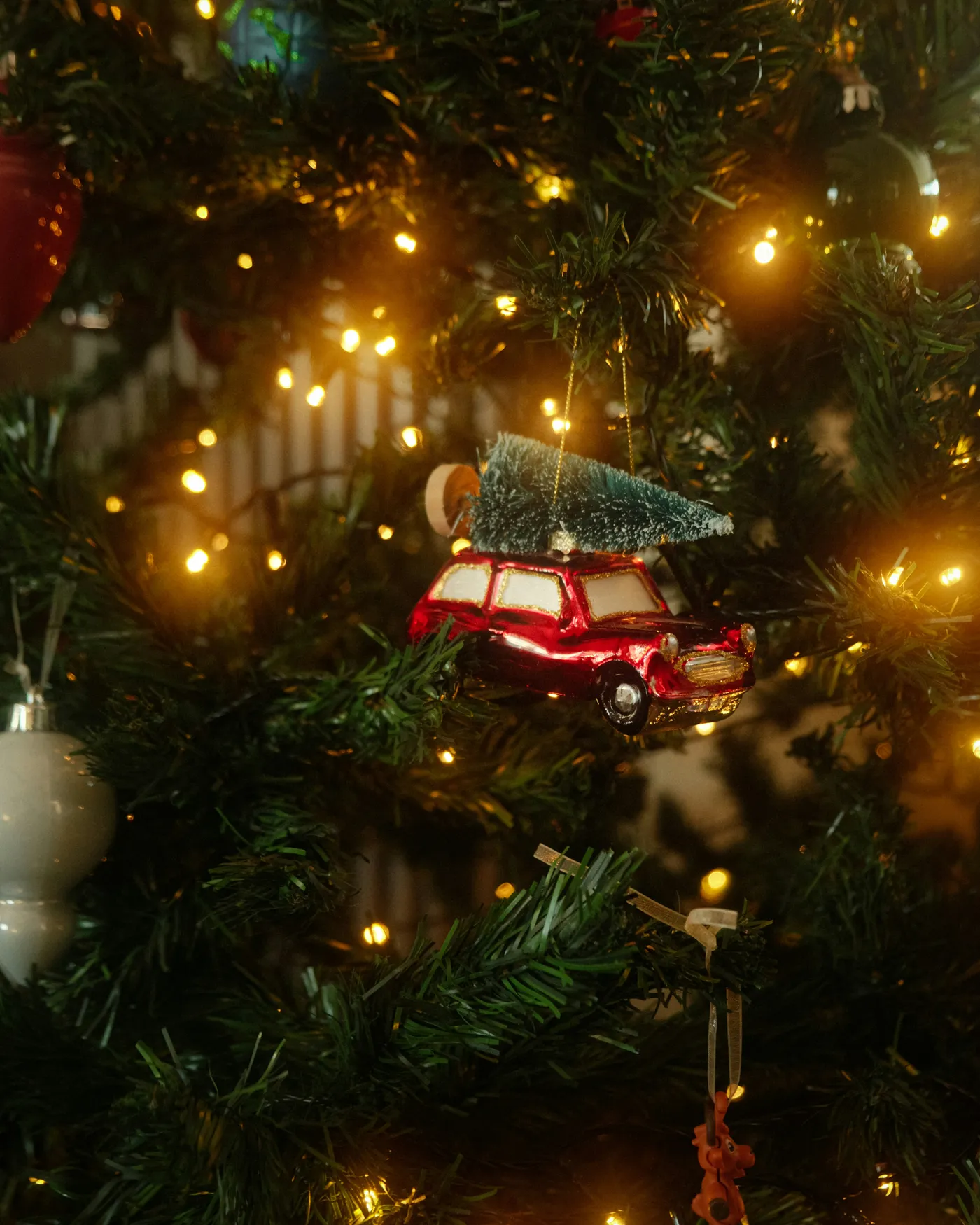 A christmas tree with a car ornament on it