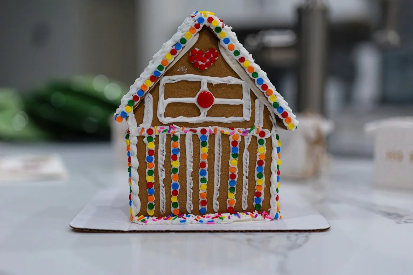 A close up of a gingerbread house on a table