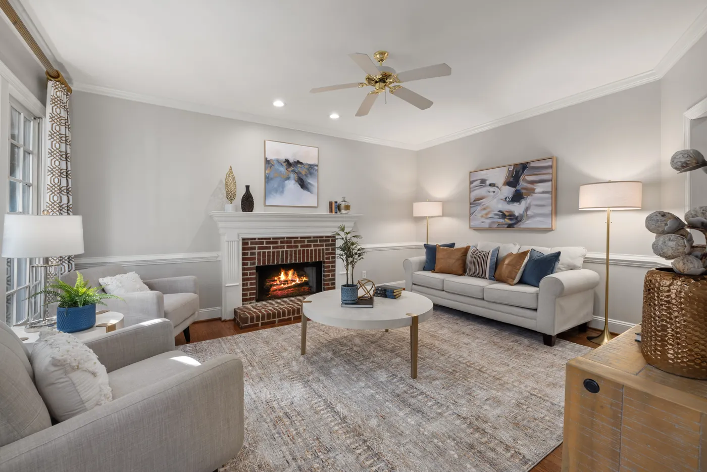 A cozy modern living room featuring a fireplace, elegant sofa, and tasteful decor.
