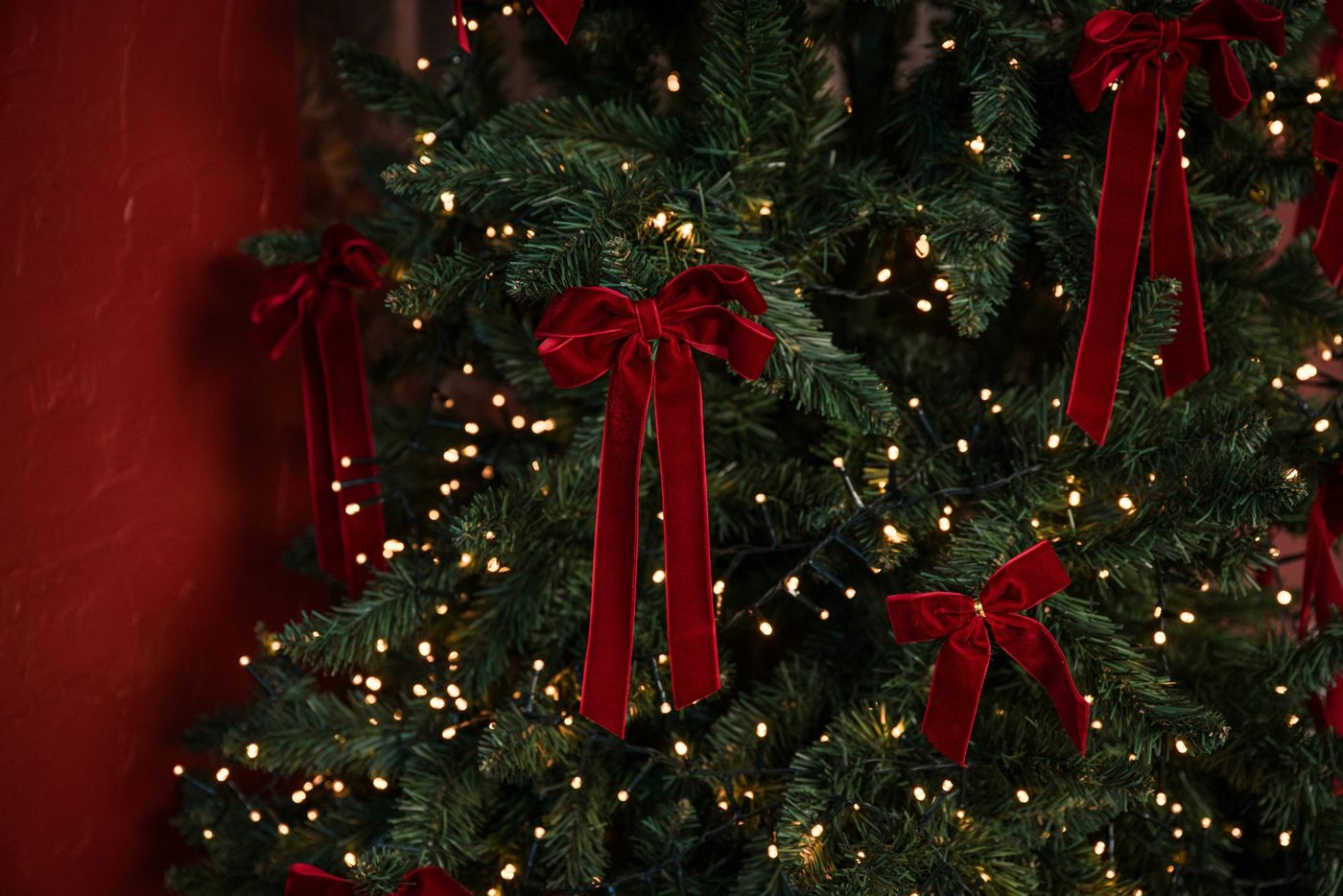 A decorated christmas tree with red bows and lights