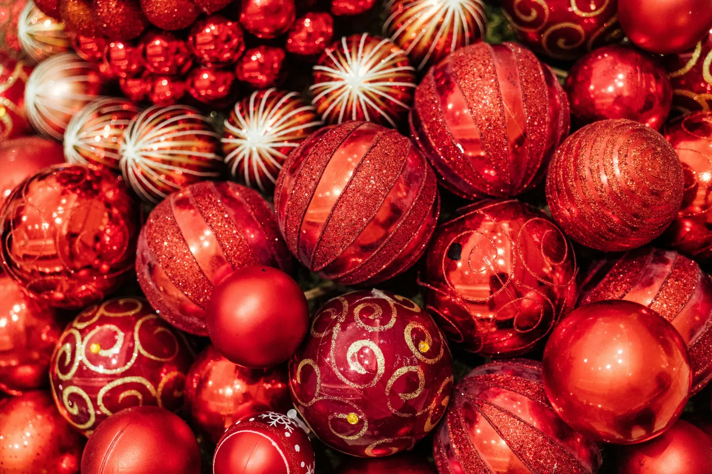 a pile of red and gold christmas ornaments