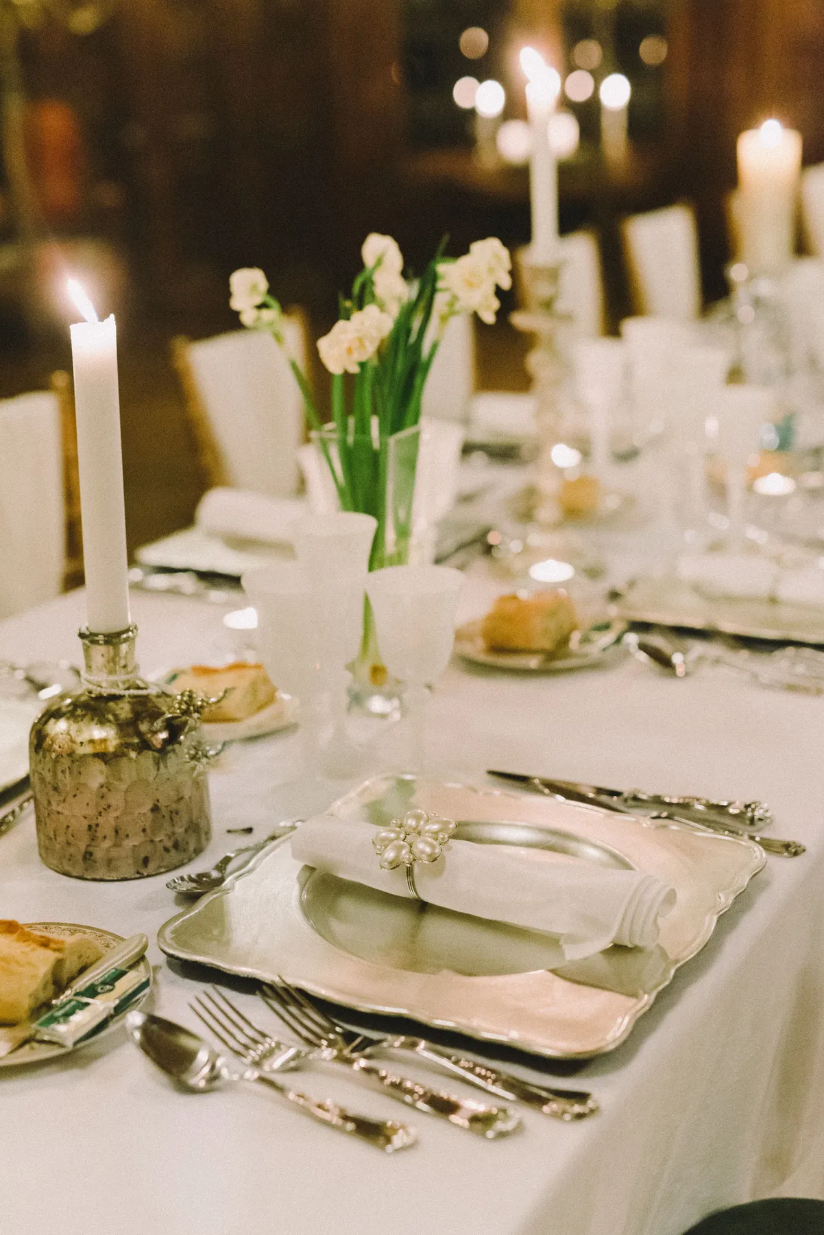 Beautifully arranged table with candles and flowers, perfect for an elegant dinner or event.