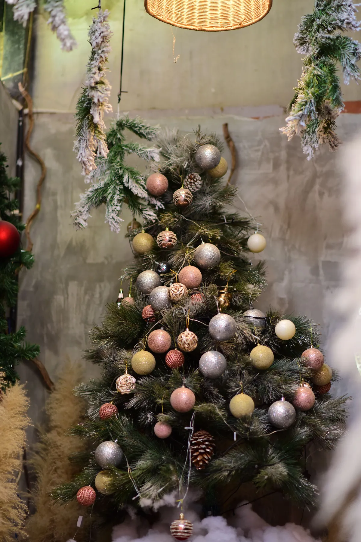 Beautifully decorated Christmas tree with ornaments and pinecones indoors.
