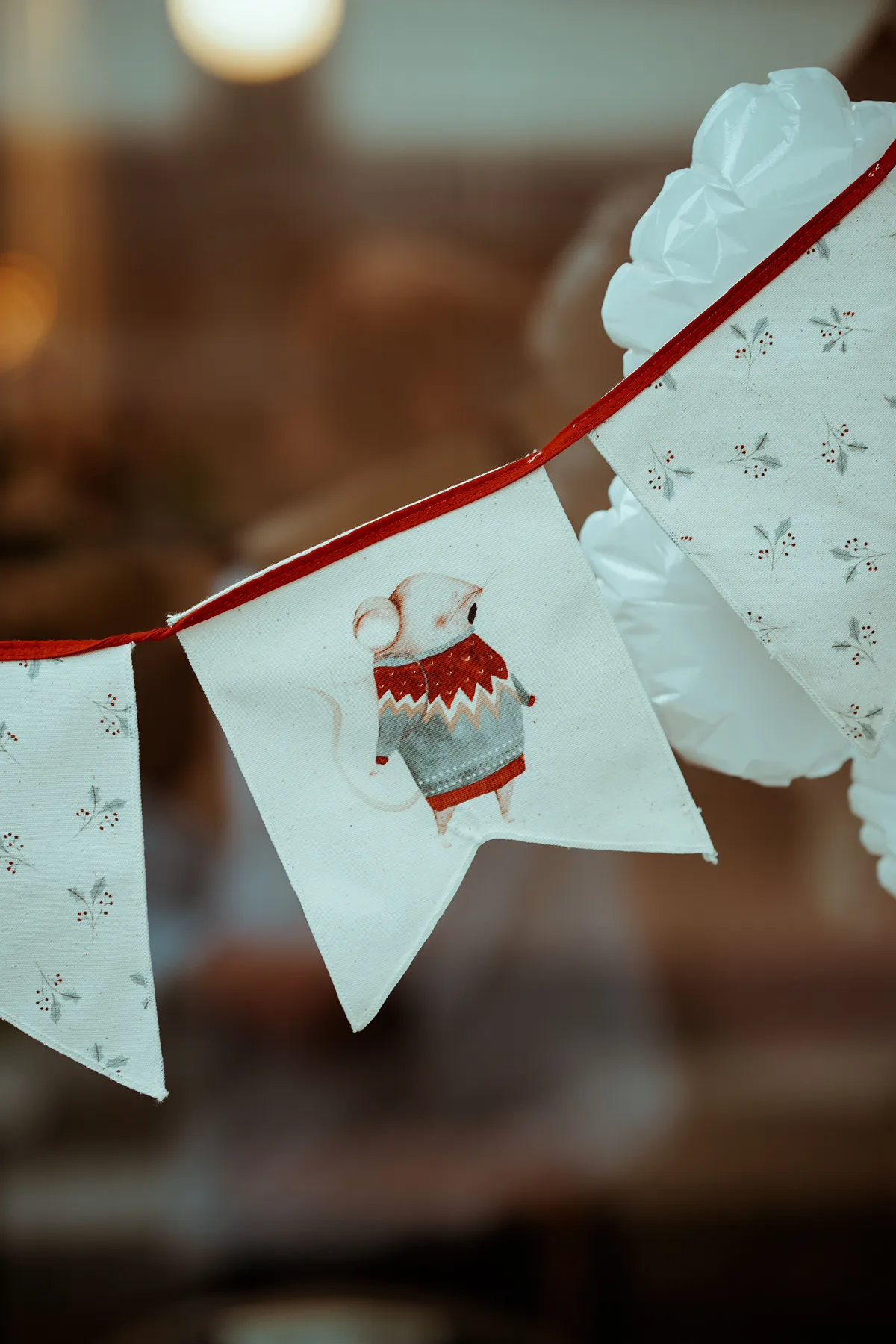 Charming indoor bunting with a mouse in a sweater, perfect for celebrations and decor.