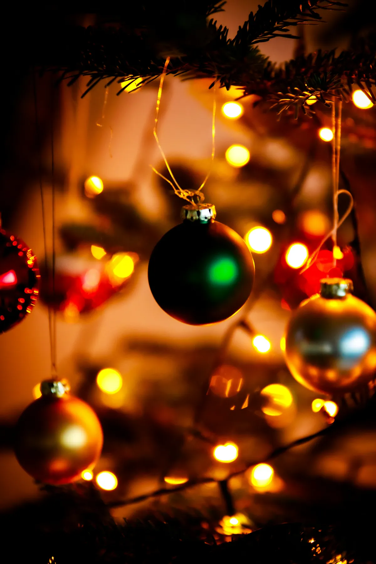 Christmas ornaments with blurred festive lights in background