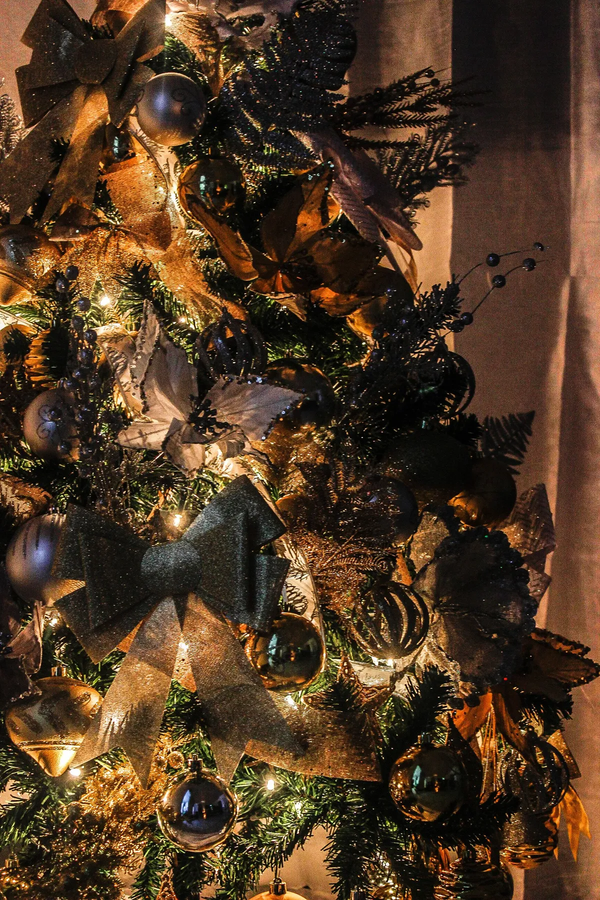 Close-up of a beautifully decorated Christmas tree with lights and ribbons in Paramaribo, Suriname.