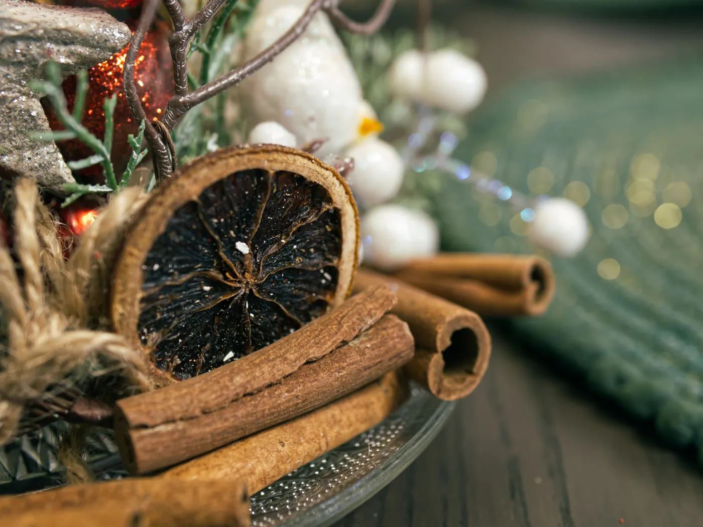 Close-up of rustic holiday decor featuring dried citrus and cinnamon sticks.