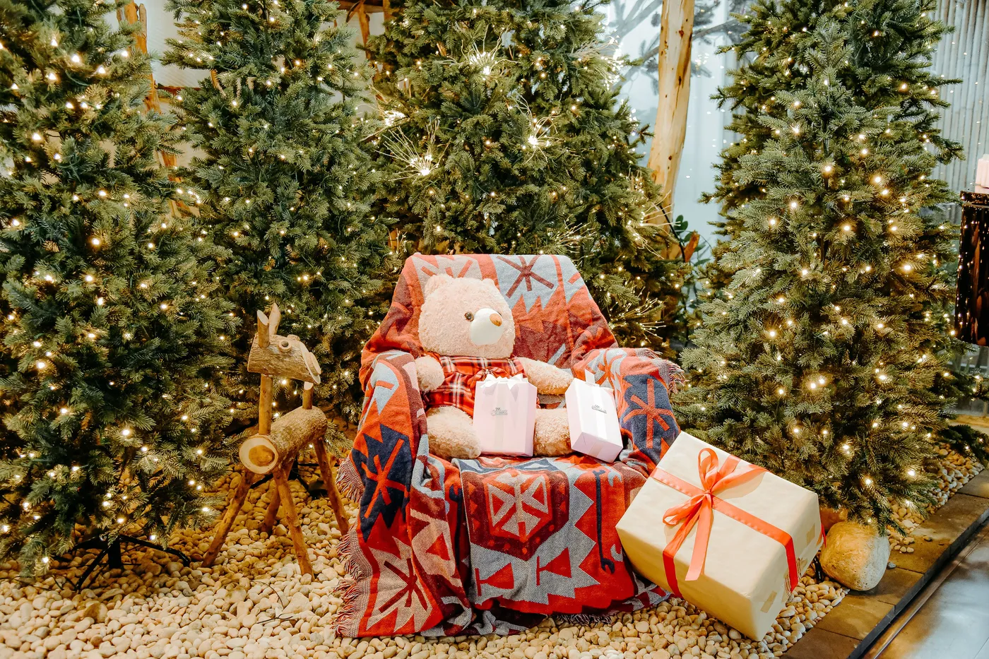 Cozy Christmas Scene with Teddy Bear and Gifts · Free Stock Photo