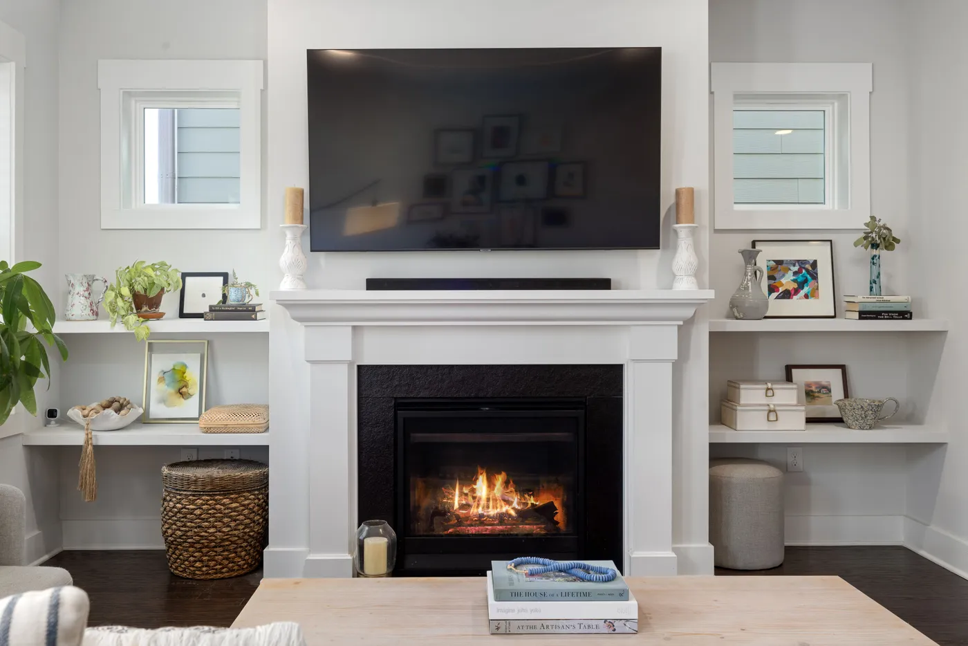 Cozy modern living room with a fireplace and large TV for a warm atmosphere.