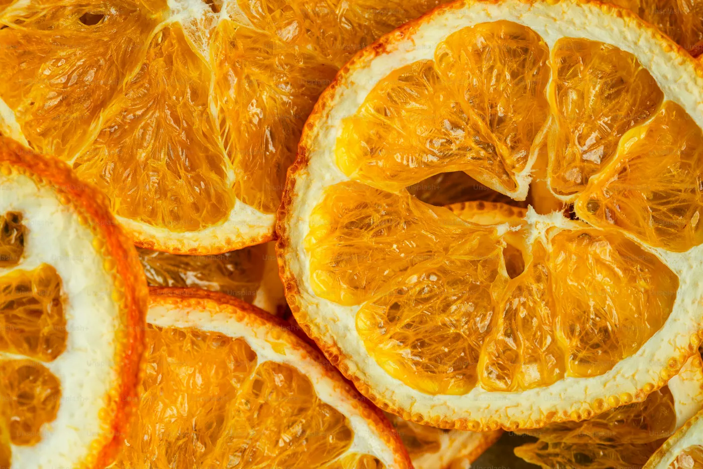 Dried orange slices fill two clear containers - Photo on Unsplash+