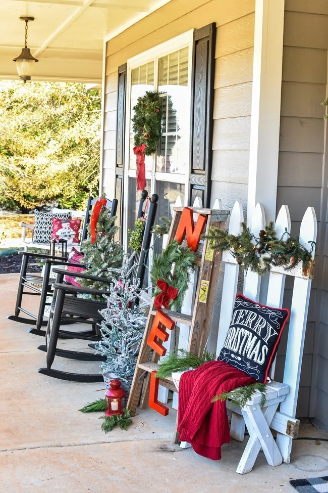 Farmhouse style Christmas front porch with picket fences