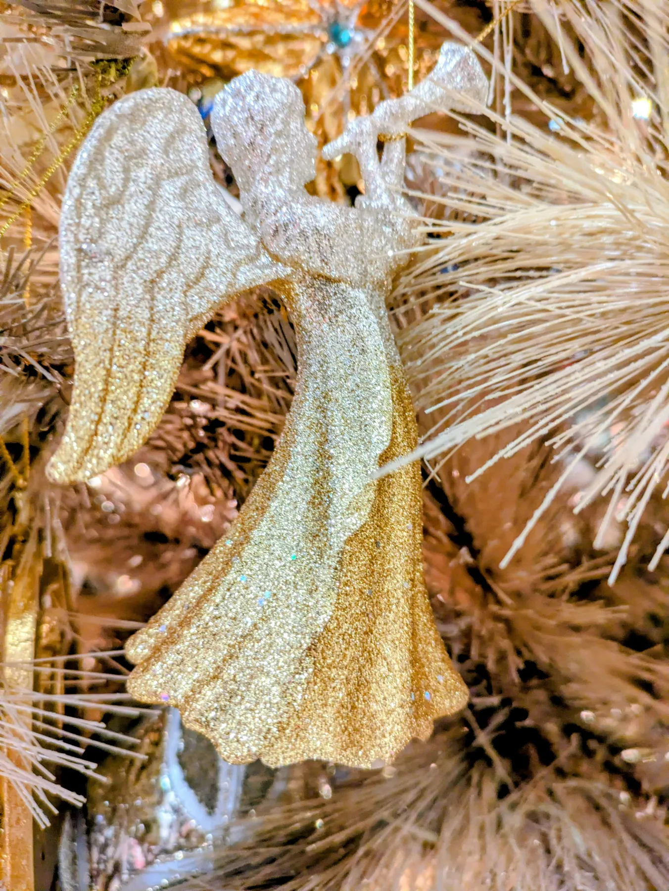 Gold and silver angel with horn ornament