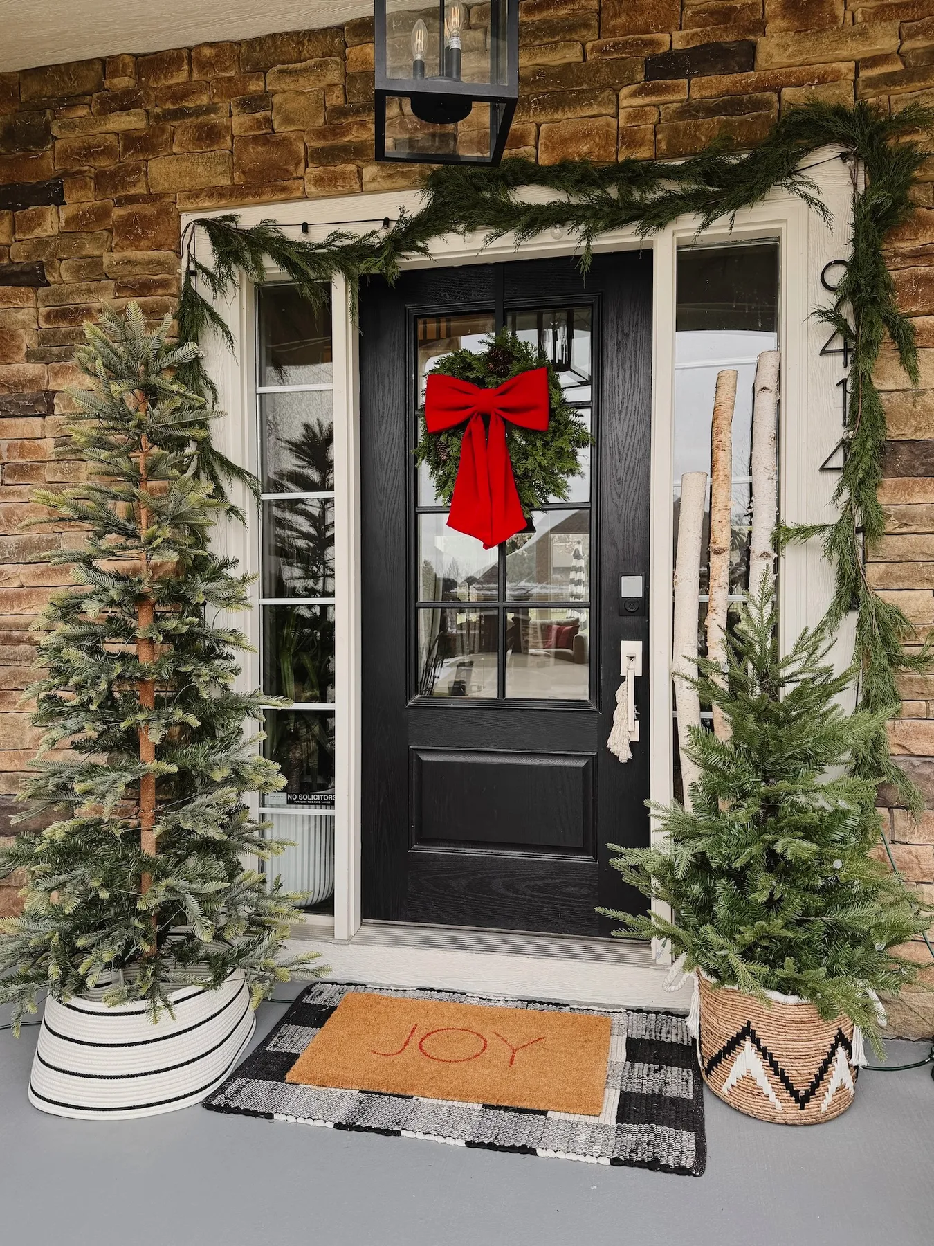How to Create a Cozy Holiday Porch with Faux Trees and Garland - Life Love Larson