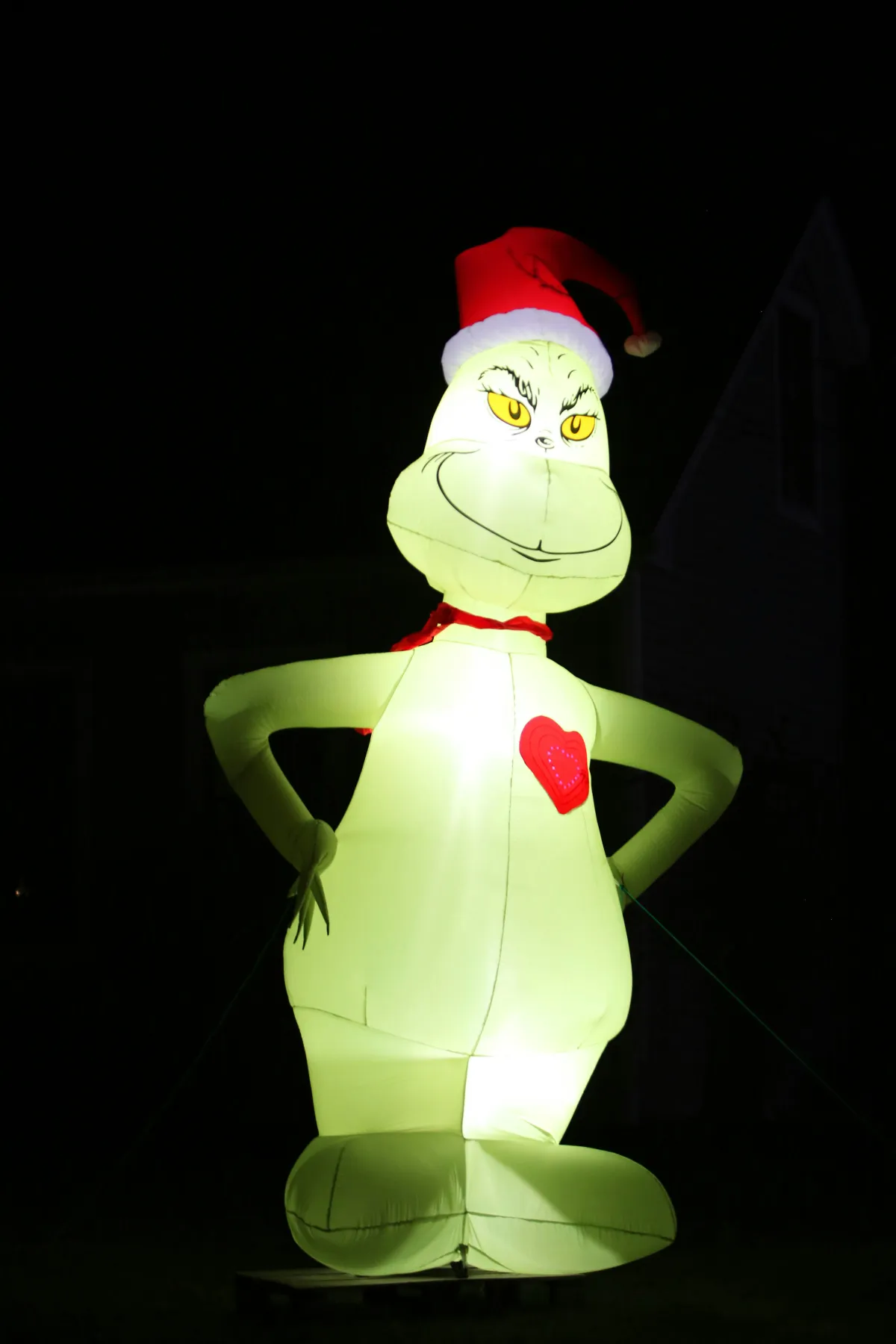 Inflatable grinch with santa hat and red heart