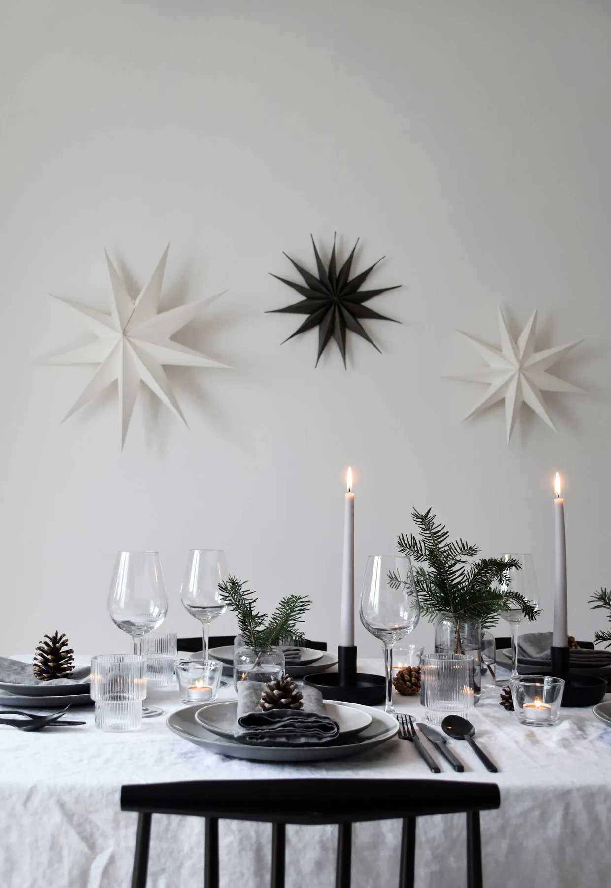 Minimalist Christmas table styling with fir, candles & pine cones |