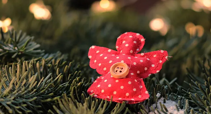 Royalty-Free photo: Angel-shaped red and white polka-dot ornament on green  surface | PickPik
