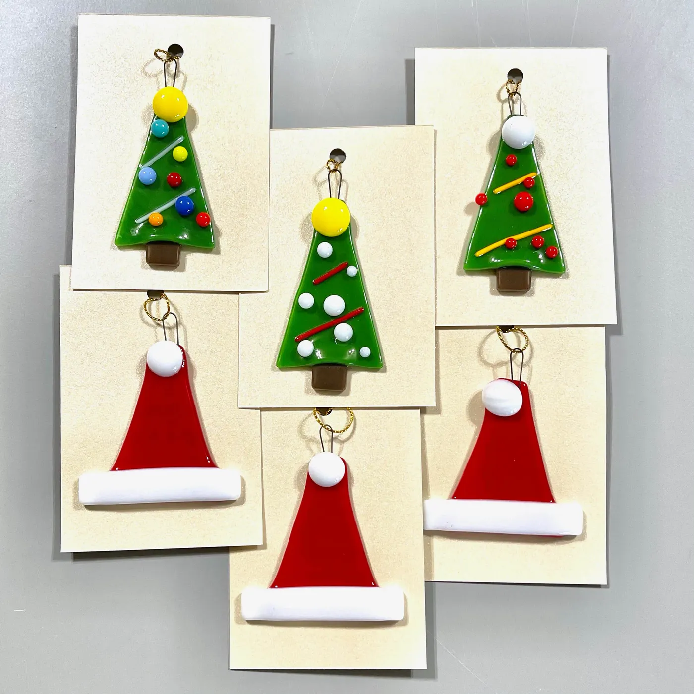 Set of Eight Fused Glass Holiday Ornaments (Six Tree and Two Santa Hat)
