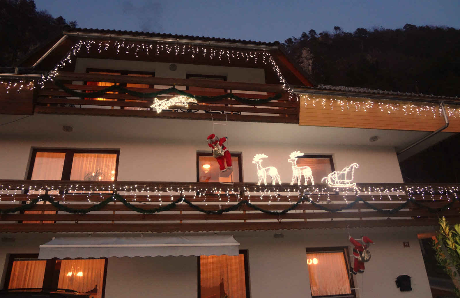 The house is decorated with Christmas lights