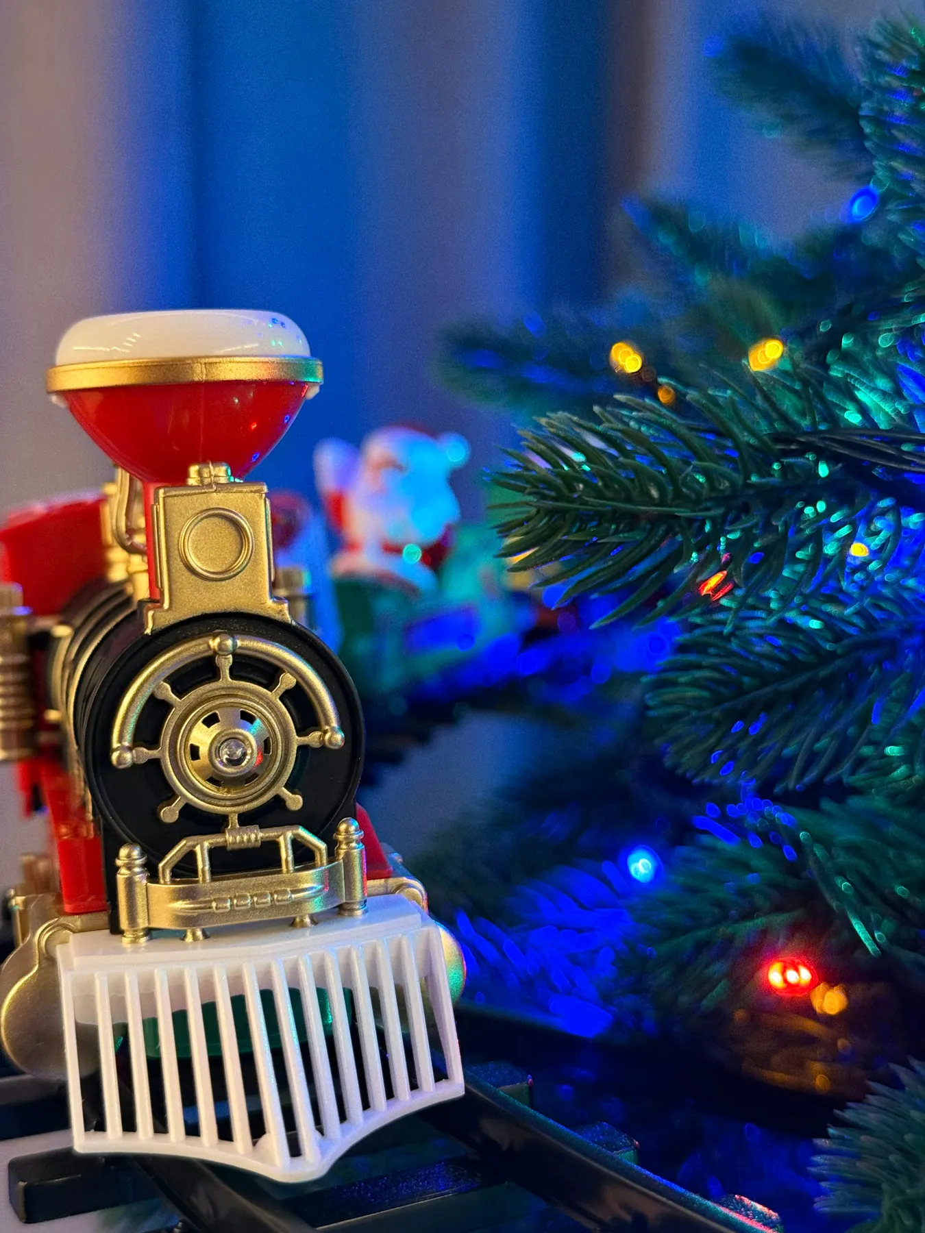 Toy train near a decorated christmas tree - Free Photo on Unsplash