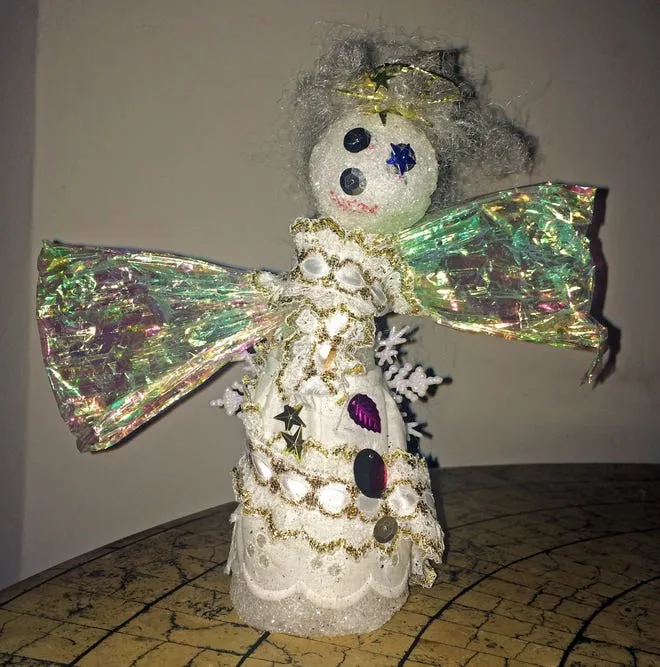 Ugly Christmas tree angel represents beauty of family