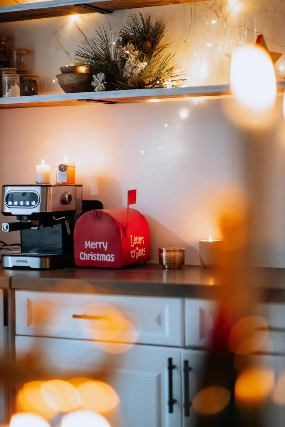 Warm Christmas ambiance in a kitchen with festive decor and mood lighting.